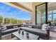 Expansive covered patio with a comfortable sectional sofa and outdoor dining at 15921 E Ridgestone Dr, Fountain Hills, AZ 85268
