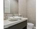 Elegant powder room showcasing a modern vessel sink, textured wallpaper, and minimalist decor at 15921 E Ridgestone Dr, Fountain Hills, AZ 85268
