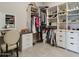 Custom walk-in closet with a vanity, offering ample storage and an organized space for clothing and accessories at 15921 E Ridgestone Dr, Fountain Hills, AZ 85268