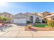 Charming home exterior boasts manicured landscaping, a two-car garage, and an inviting entrance at 15923 W Paradise Ln, Surprise, AZ 85374