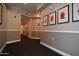Well-maintained hallway with framed floral artwork and neutral color scheme at 1701 E Colter St # 226, Phoenix, AZ 85016