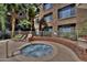 Unwind in the hot tub with views of lush landscaping and the building's architecture at 1701 E Colter St # 226, Phoenix, AZ 85016