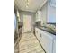 Galley kitchen featuring stainless steel appliances, light gray backsplash and granite countertops at 1701 E Colter St # 226, Phoenix, AZ 85016