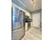 Modern kitchen with stainless steel appliances, white cabinetry, and tile flooring at 1701 E Colter St # 226, Phoenix, AZ 85016