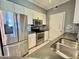 Modern kitchen featuring stainless steel appliances, white cabinets, gray backsplash and sink at 1701 E Colter St # 226, Phoenix, AZ 85016