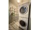 A stacked washer and dryer set is accompanied by shelving in this convenient laundry room at 1701 E Colter St # 226, Phoenix, AZ 85016