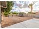 Spacious backyard is a blank canvas with desert landscaping, a trampoline, and mature trees at 1713 E Westchester Dr, Tempe, AZ 85283