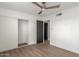 This bedroom features hardwood floors, neutral paint and a ceiling fan at 1713 E Westchester Dr, Tempe, AZ 85283