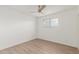 Bright bedroom featuring wood-look floors, fresh paint, and a window at 1713 E Westchester Dr, Tempe, AZ 85283