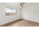 This bedroom has a large window with a view of the backyard and a ceiling fan at 1713 E Westchester Dr, Tempe, AZ 85283
