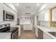 Well-lit, eat-in kitchen showcasing stainless steel appliances and white cabinetry at 1713 E Westchester Dr, Tempe, AZ 85283