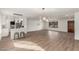 Bright living space with wood-look floors flowing into a modern kitchen area with pendant lighting at 1713 E Westchester Dr, Tempe, AZ 85283