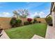 Backyard with an artificial lawn, brick pavers and a beautiful garden, perfect for outdoor enjoyment and relaxation at 1752 N Harper --, Mesa, AZ 85207