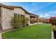 Exterior view of the home with a covered patio and artificial lawn, offering a relaxing outdoor space at 1752 N Harper --, Mesa, AZ 85207
