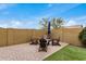 Backyard seating area featuring brick pavers, a cozy fire pit, comfortable chairs, and an umbrella for shade at 1752 N Harper --, Mesa, AZ 85207