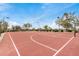 Red basketball court featuring multiple hoops surrounded by desert vegetation at 1752 N Harper --, Mesa, AZ 85207