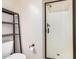 Bathroom with toilet, wall shelving, and glass walk-in shower with bronze hardware at 1752 N Harper --, Mesa, AZ 85207