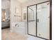 Bathroom featuring a soaking tub, glass-enclosed shower, and neutral tile flooring at 1752 N Harper --, Mesa, AZ 85207