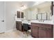 Bathroom featuring dual sinks, modern fixtures, vanity space and a glass door shower at 1752 N Harper --, Mesa, AZ 85207