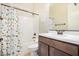 Bathroom featuring tub and shower, dinosaur themed shower curtain, and wooden vanity at 1752 N Harper --, Mesa, AZ 85207