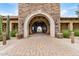 Elegant clubhouse archway, featuring stone architecture and inviting pathway at 1752 N Harper --, Mesa, AZ 85207