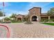 Stunning stone clubhouse entrance with arched entryway and manicured landscaping at 1752 N Harper --, Mesa, AZ 85207