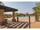 Community pool with a sunshade structure offering a relaxing and social gathering spot for residents at 1752 N Harper --, Mesa, AZ 85207