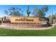 A stone monument with 'Mountain Bridge' sign surrounded by desert landscaping and vibrant flowers at 1752 N Harper --, Mesa, AZ 85207