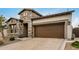Stunning exterior view of the home with stone accents, a wide driveway, and a welcoming entrance at 1752 N Harper --, Mesa, AZ 85207