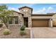 Charming stone-clad home featuring a paver driveway and well-maintained, drought-resistant landscaping at 1752 N Harper --, Mesa, AZ 85207