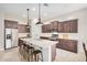 Spacious kitchen featuring a large center island, granite countertops, stainless steel appliances, and dark wood cabinets at 1752 N Harper --, Mesa, AZ 85207