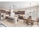 Bright kitchen with stainless steel appliances, granite countertops, a large island, and a cozy dining area at 1752 N Harper --, Mesa, AZ 85207