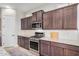 Well-equipped kitchen featuring stainless steel appliances, granite countertops, and dark cabinetry at 1752 N Harper --, Mesa, AZ 85207