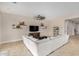 Living room featuring a sectional sofa, decorative shelves, modern fan and an open floor plan at 1752 N Harper --, Mesa, AZ 85207