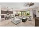 Bright living room with a large sofa, modern fan and an open view to the kitchen and the backyard at 1752 N Harper --, Mesa, AZ 85207