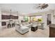Bright living room with a large sofa, modern fan and an open view to the kitchen and the backyard at 1752 N Harper --, Mesa, AZ 85207
