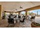 Relaxing outdoor lounge area with fireplace and covered seating with desert views at 1752 N Harper --, Mesa, AZ 85207
