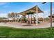 A well-maintained playground with a large sunshade covering play structures, slides and play equipment at 1752 N Harper --, Mesa, AZ 85207