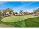 Manicured putting green providing a recreational amenity with desert plants and landscape at 1752 N Harper --, Mesa, AZ 85207