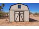 This is a well-built shed with a window that conveys with the sale of this lot with a large double door at 1811 W Joy Ranch Rd, Phoenix, AZ 85086