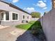 Well-maintained backyard with green grass, gravel area and block wall at 2014 S Archer Cir, Mesa, AZ 85209