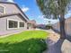 Lush backyard features green lawn, mature tree, pool and covered patio at 2014 S Archer Cir, Mesa, AZ 85209