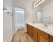 Bright bathroom boasts dual sinks and wood look floor at 2014 S Archer Cir, Mesa, AZ 85209