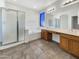 Bathroom featuring dual sinks, a soaking tub, and a separate glass shower at 2014 S Archer Cir, Mesa, AZ 85209