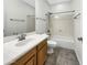 Clean bathroom with a single vanity, tile floors, and a shower-tub combo at 2014 S Archer Cir, Mesa, AZ 85209