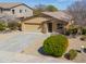 Single-story home with a two-car garage, desert landscaping, and stone veneer accents at 208 S La Amador Trl, Casa Grande, AZ 85194