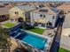 Aerial view showcases a sparkling pool, hot tub, artificial turf, and outdoor living space at 20867 N Grantham Rd, Maricopa, AZ 85138