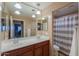 Clean bathroom with double sink vanity and modern fixtures with a shower and tub behind a curtain at 20867 N Grantham Rd, Maricopa, AZ 85138