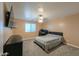 Bedroom with a large bed, television, modern ceiling fan, and plush carpeting at 20867 N Grantham Rd, Maricopa, AZ 85138