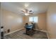 Cozy bedroom with a ceiling fan, neutral paint, and plank flooring. Features a large window at 20867 N Grantham Rd, Maricopa, AZ 85138